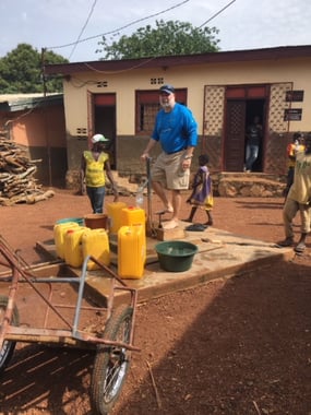 Taking my turn on the water well pump at an orphanage in Bangui, CAR